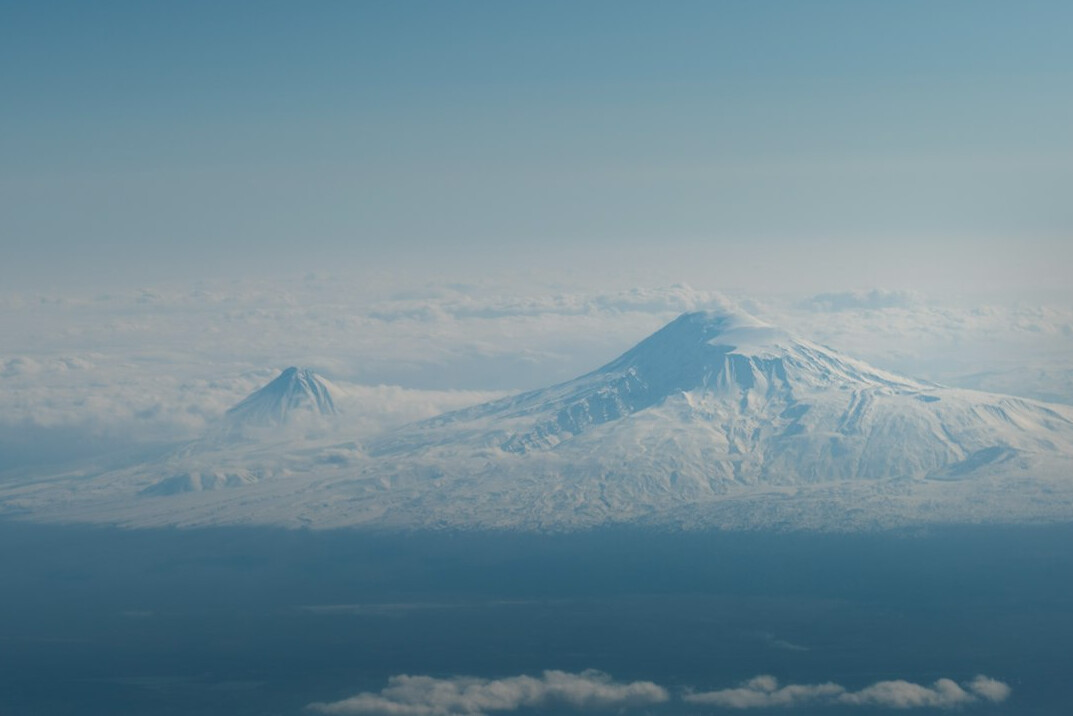 Snow-capped mountain peaks above clouds