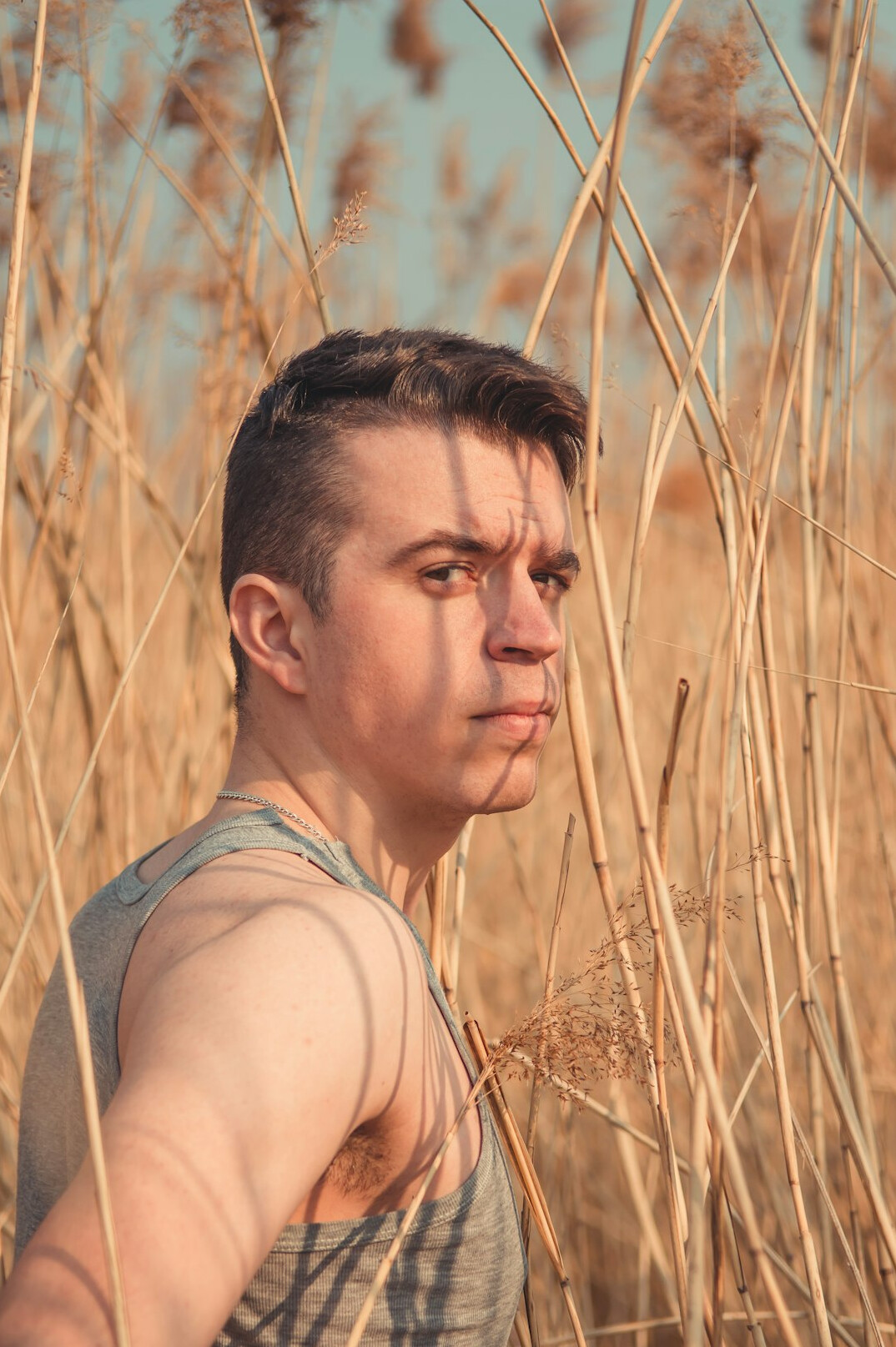 Portrait of a young man with short hair outdoors