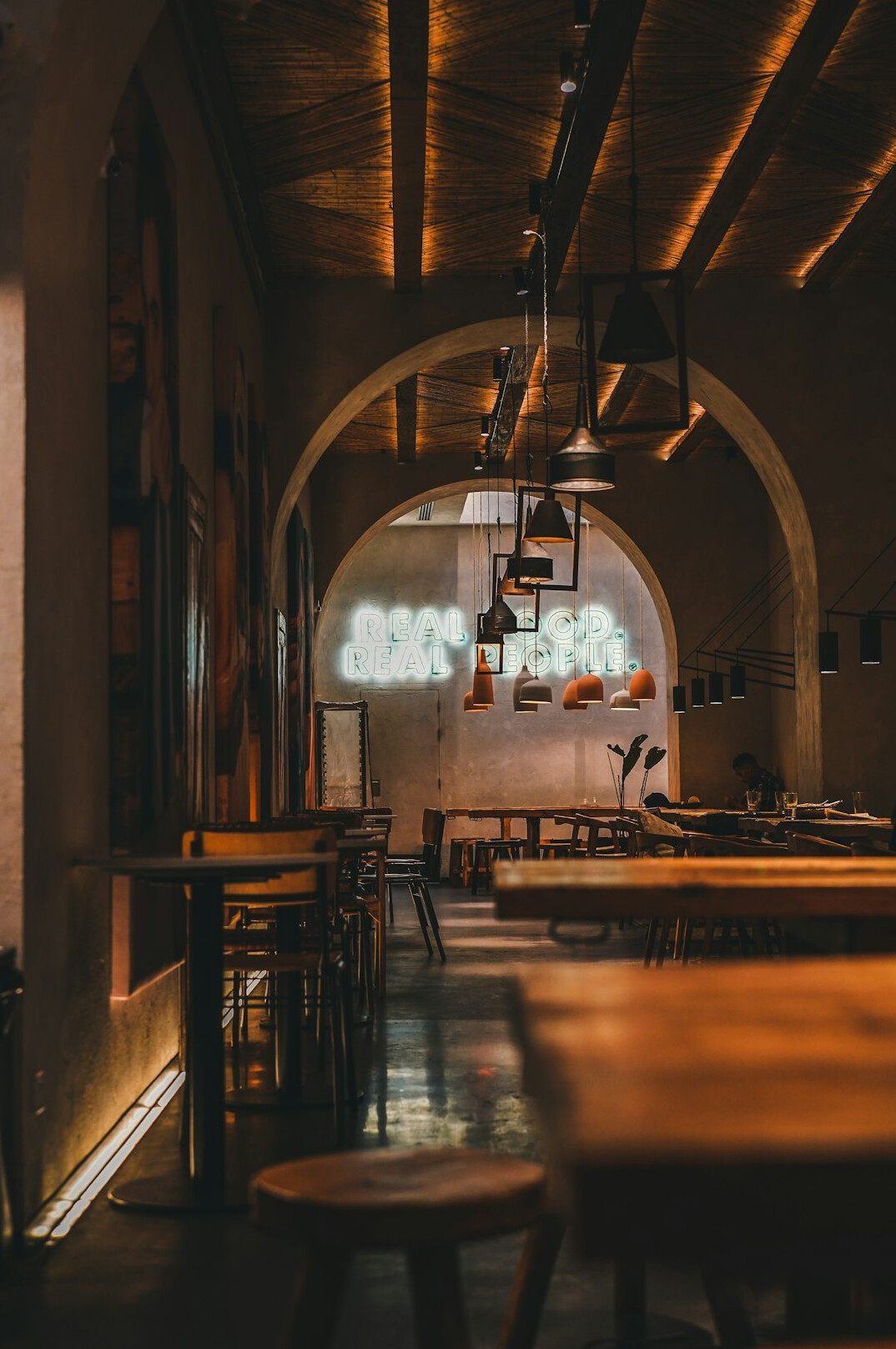 Cozy restaurant interior with wooden tables and warm lights